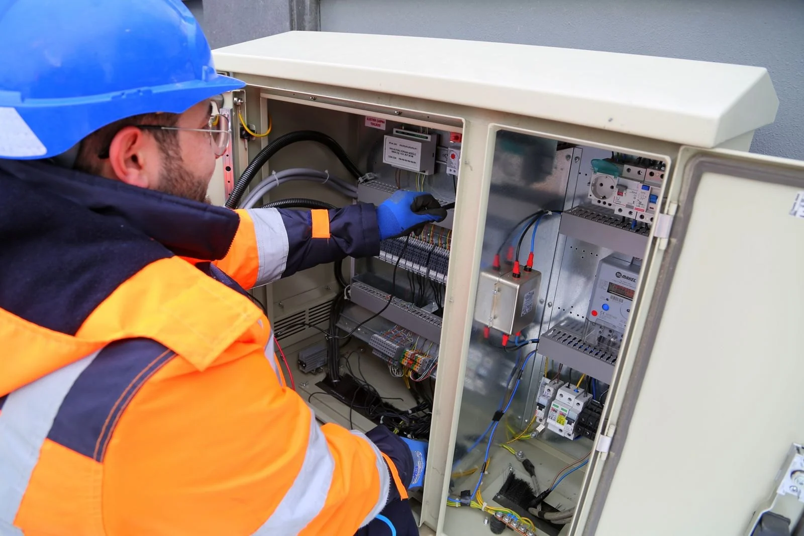 Technician working by a fuse box