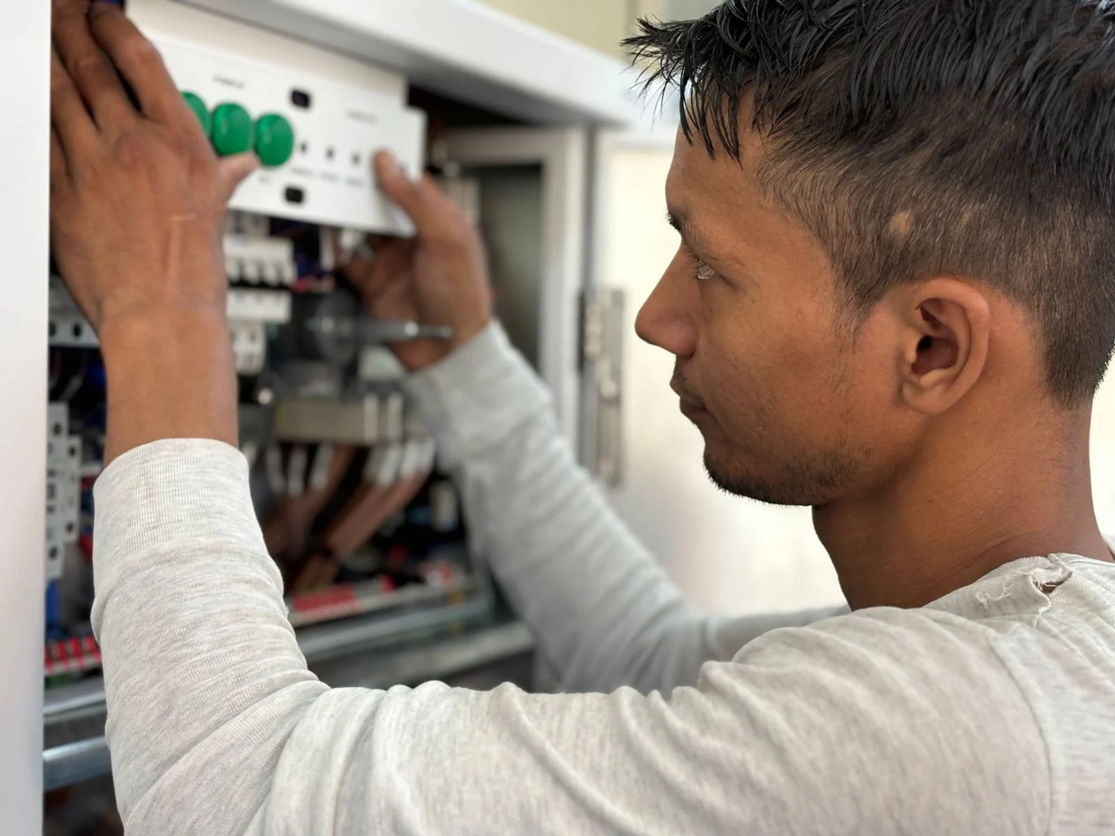 Electrician adjusting an electrical panel
