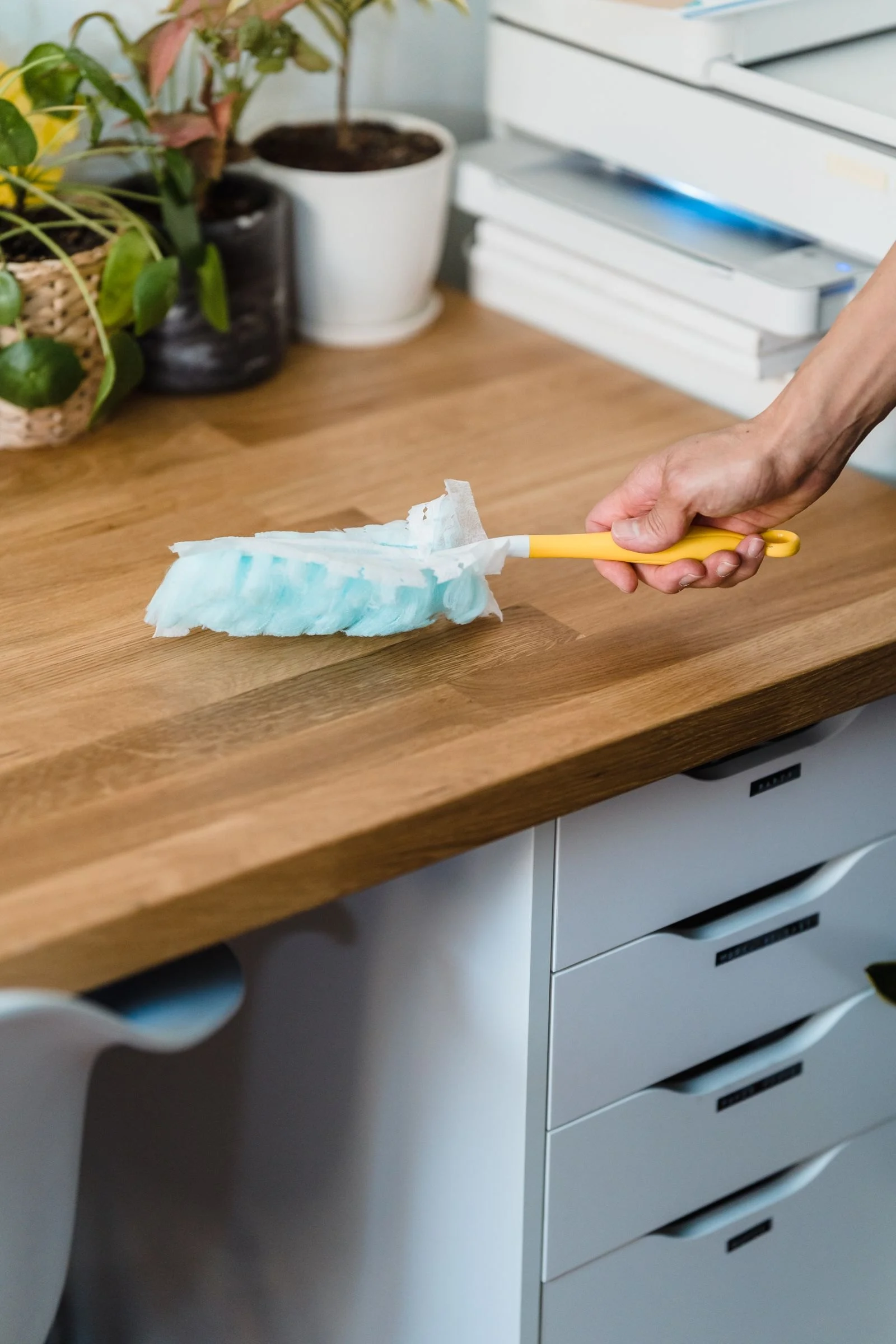 Dusting a desk surface